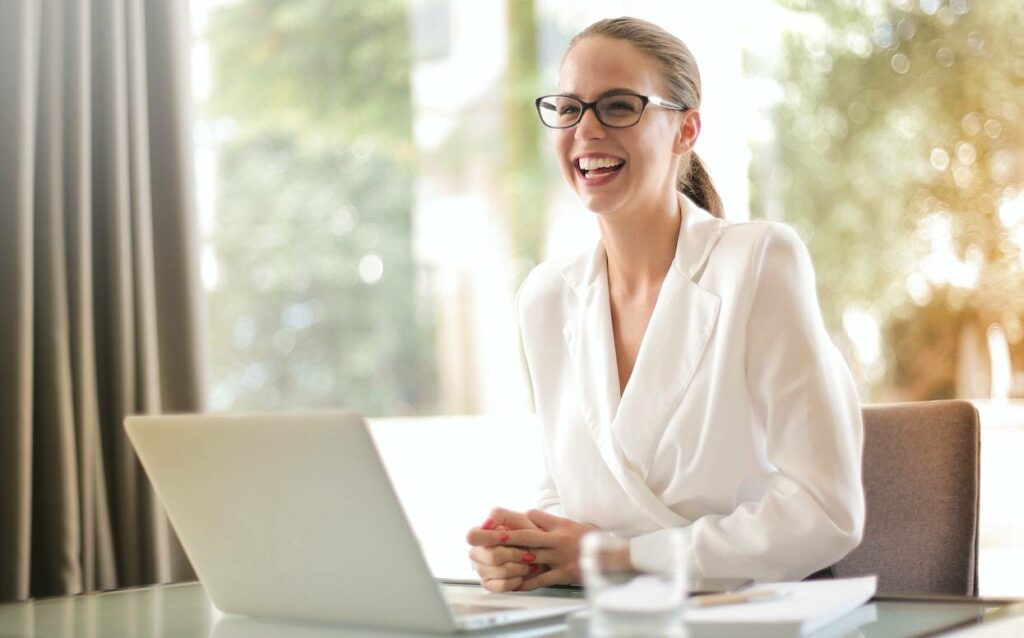 Image showing a young lady in glasses smiling during a job interview situation