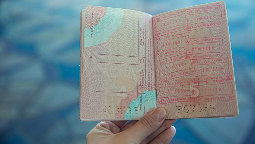 Image showing an open passport with stamps for visas
